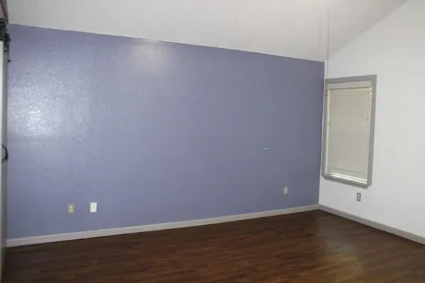 a view of an empty room and wooden floor