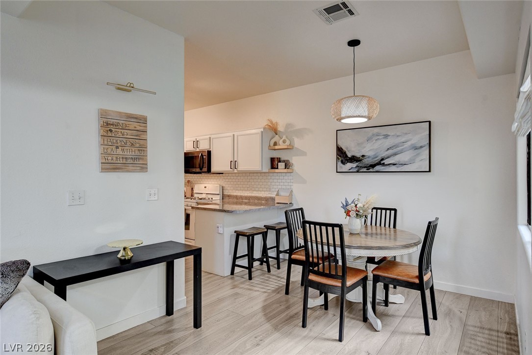 64 Brown Swallow Way Henderson, NV 89012 - Photo 11 of 42 Dining room with light wood-style flooring and baseboards