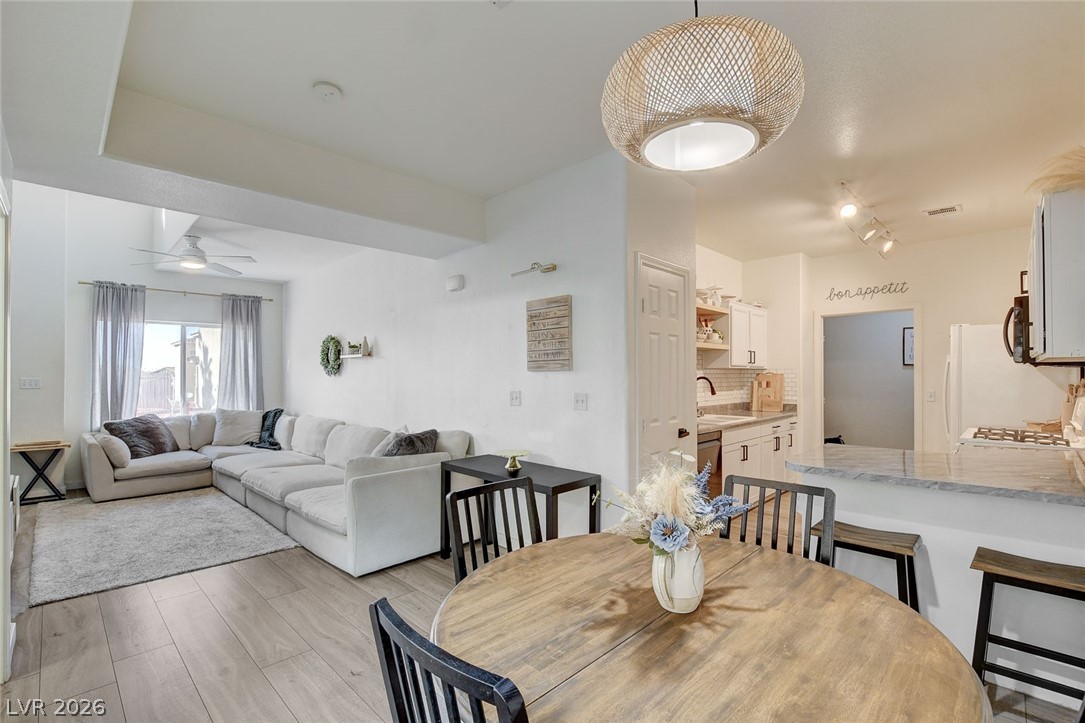 64 Brown Swallow Way Henderson, NV 89012 - Photo 14 of 42 Dining room with light wood-style flooring and ceiling fan