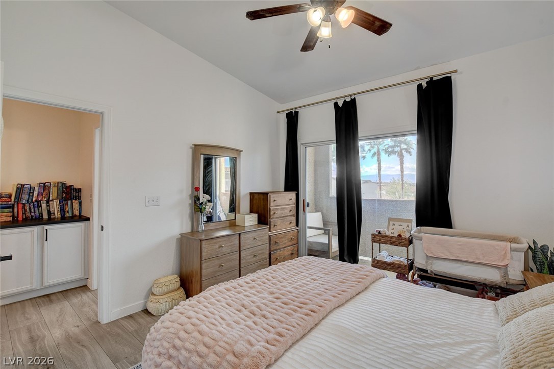 64 Brown Swallow Way Henderson, NV 89012 - Photo 24 of 42 Bedroom with light wood-style flooring, lofted ceiling, and ceiling fan