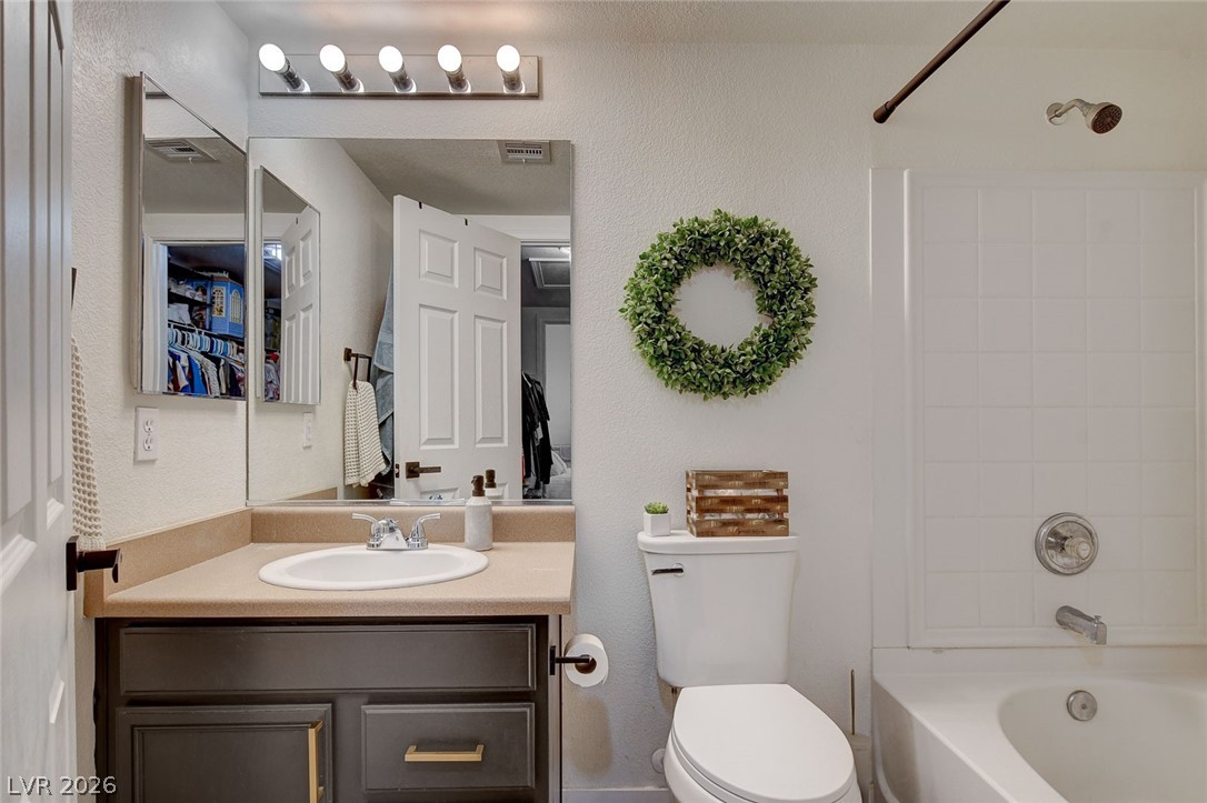 64 Brown Swallow Way Henderson, NV 89012 - Photo 27 of 42 Full bath featuring vanity, shower / washtub combination, and a textured wall