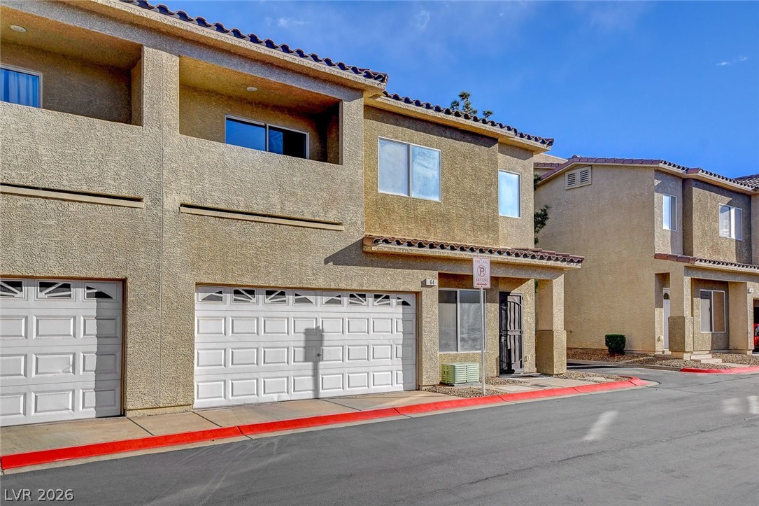 64 Brown Swallow Way Henderson, NV 89012 - Photo 37 of 42 View of front facade with stucco siding and a garage