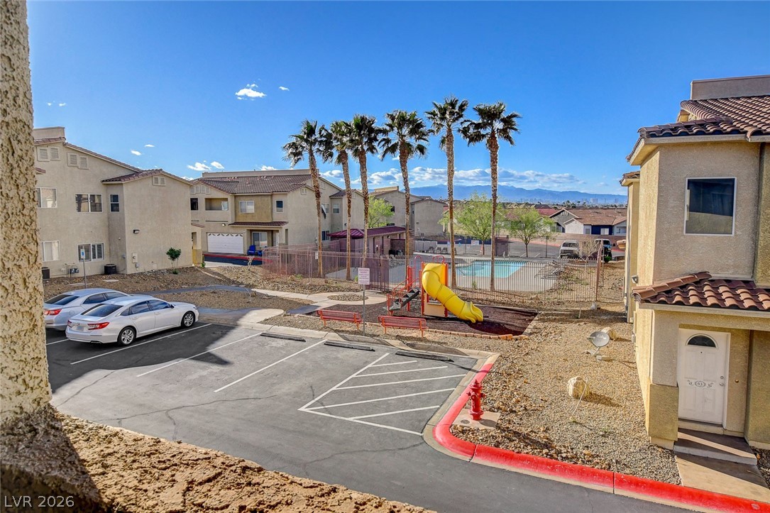 64 Brown Swallow Way Henderson, NV 89012 - Photo 38 of 42 Uncovered parking lot featuring a residential view