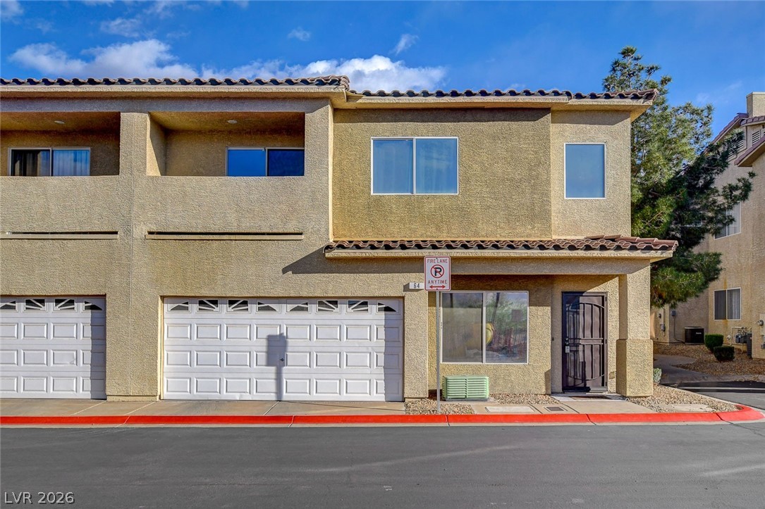 64 Brown Swallow Way Henderson, NV 89012 - Photo 7 of 42 View of front of property with stucco siding and an attached garage