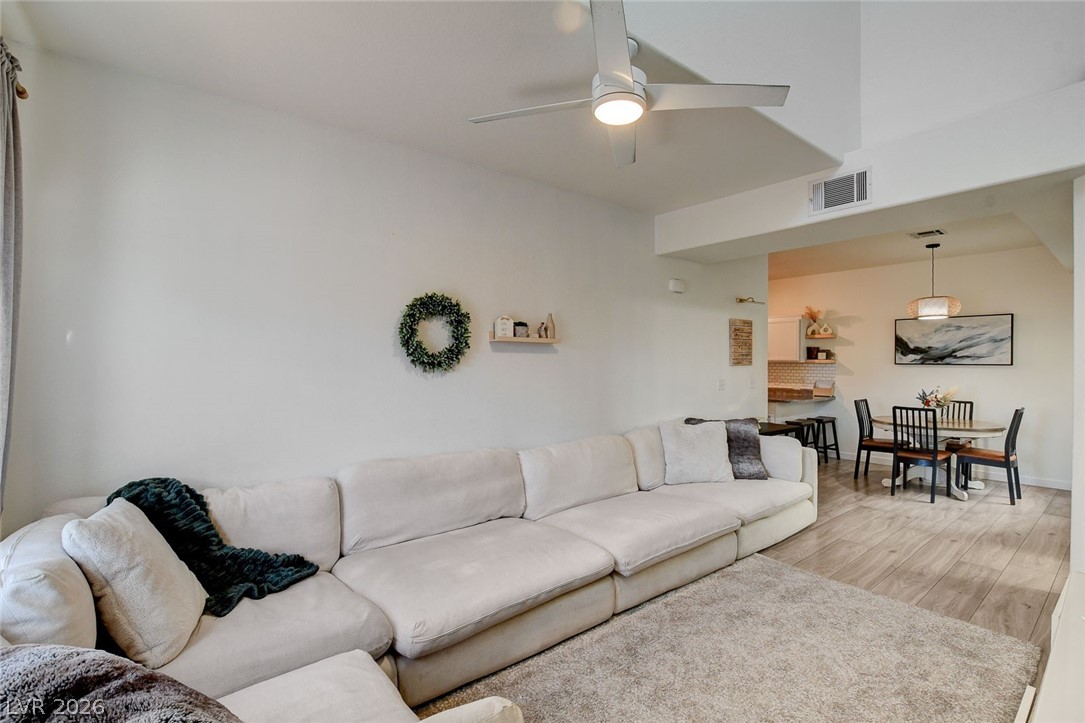 64 Brown Swallow Way Henderson, NV 89012 - Photo 8 of 42 Living area featuring light wood-type flooring and a ceiling fan