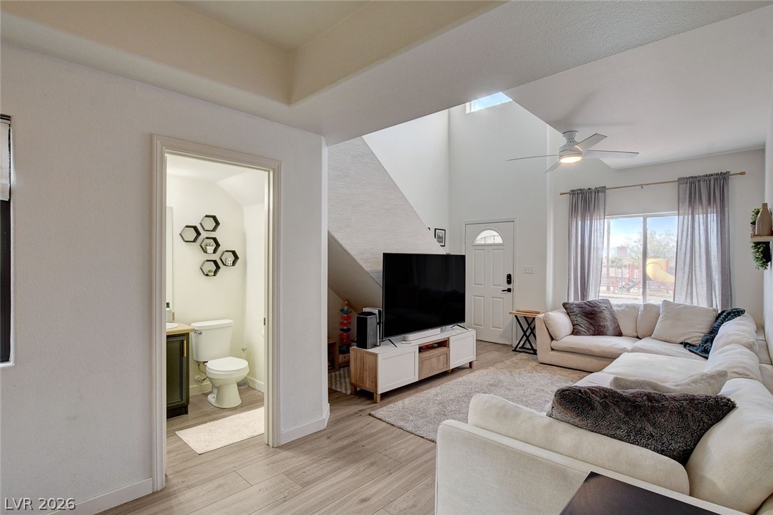 64 Brown Swallow Way Henderson, NV 89012 - Photo 10 of 42 Living area with light wood finished floors, ceiling fan, and a high ceiling