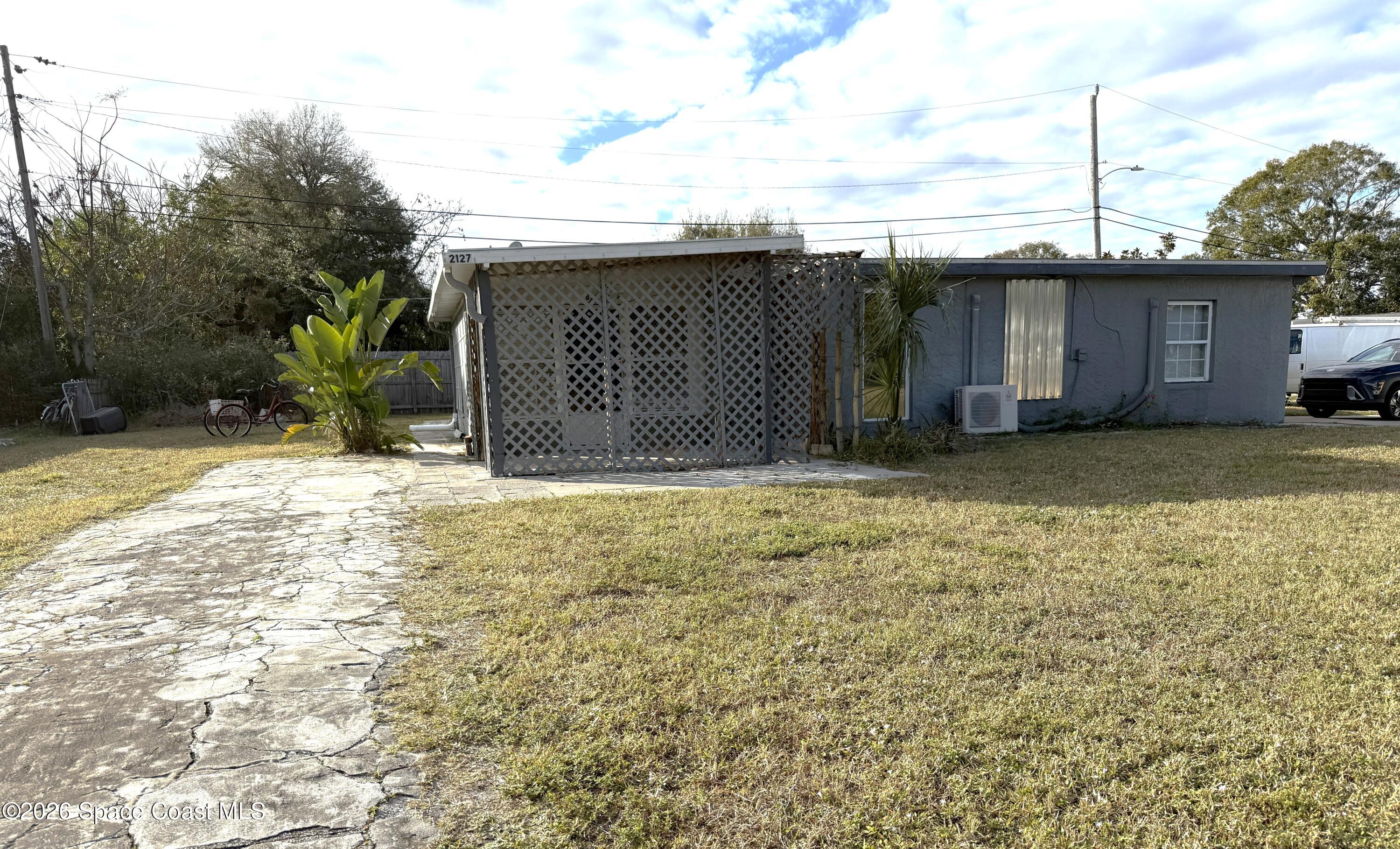 2127 Smathers Circle South, Unit B Melbourne, FL 32935 - Photo 1 of 32 a view of a house with a yard