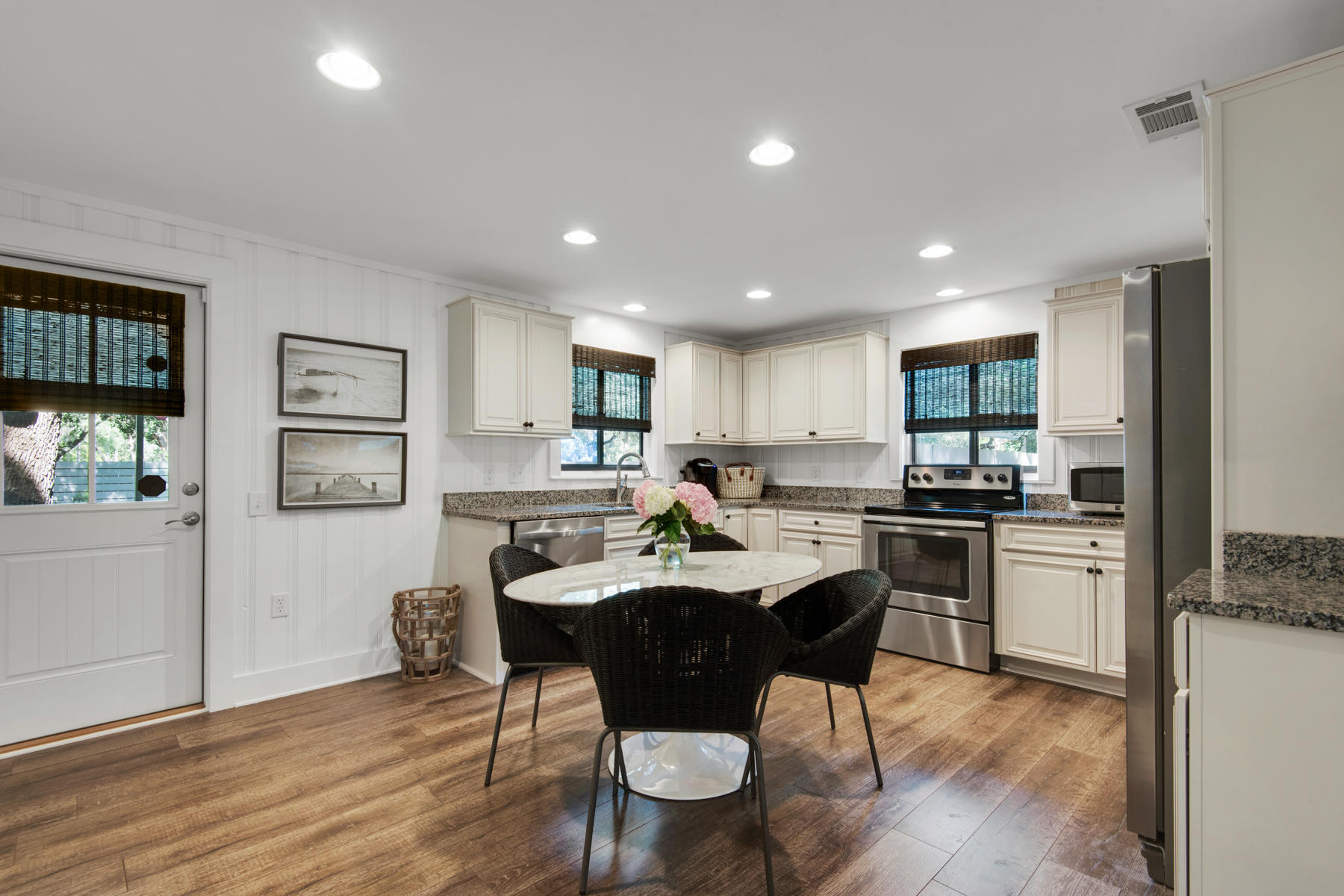 537 Ricker Avenue Santa Rosa Beach, FL 32459 - Photo 4 of 18 a kitchen with stainless steel appliances kitchen island granite countertop a sink table and chairs