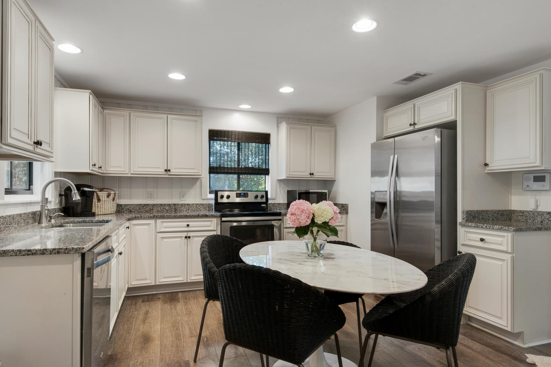 537 Ricker Avenue Santa Rosa Beach, FL 32459 - Photo 5 of 18 a kitchen with a refrigerator a stove a sink dishwasher with a dining table and chair