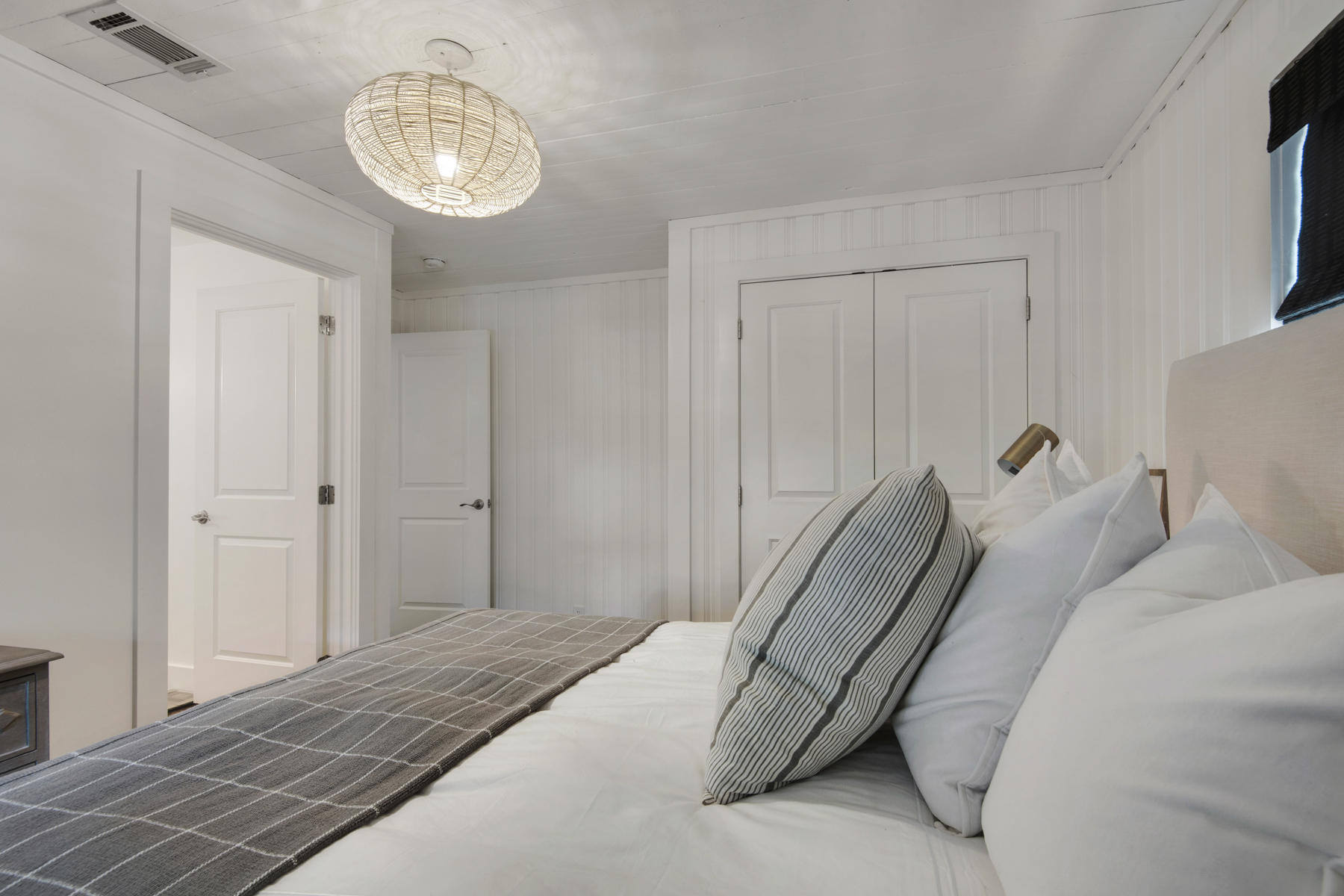 537 Ricker Avenue Santa Rosa Beach, FL 32459 - Photo 8 of 18 a bedroom with a bed and a chandelier