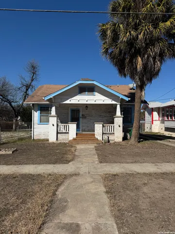 a front view of a house with a garden and a garage