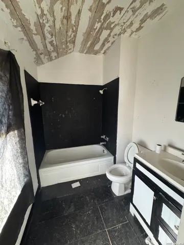 a bathroom with a bathtub and toilet
