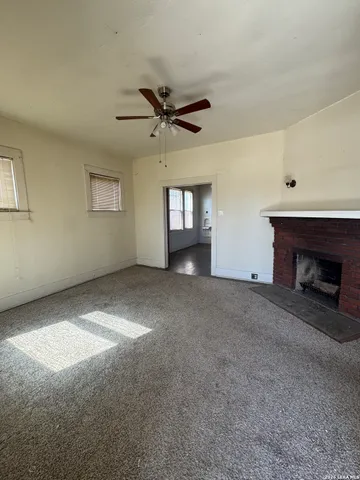 a view of empty room with a fireplace