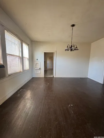 an empty room with a empty space and windows