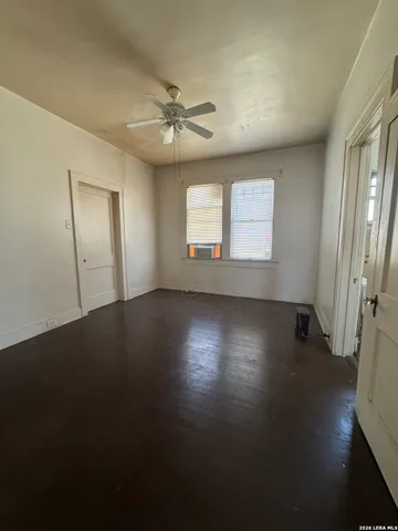 a view of a livingroom with wooden floor and a window
