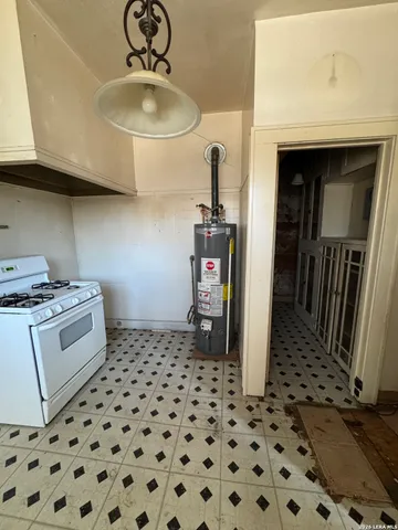 a kitchen with a sink a stove and cabinets