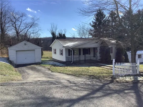 a front view of a house with a yard and a garage