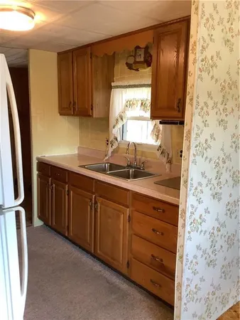 a kitchen with stainless steel appliances granite countertop a sink stove and cabinets