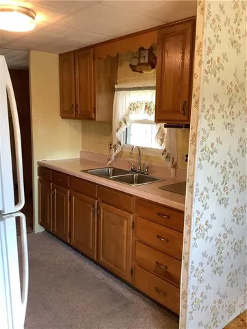 a kitchen with stainless steel appliances granite countertop a sink stove and cabinets