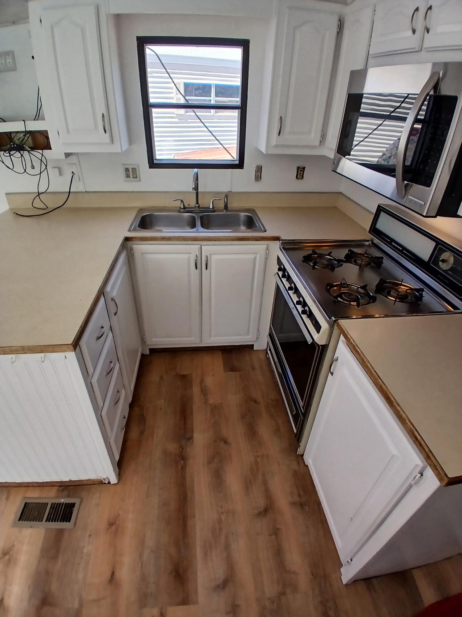 3750 Paradise Road, Unit 100 Santa Barbara, CA 93105 - Photo 5 of 14 a kitchen with sink a stove and cabinets