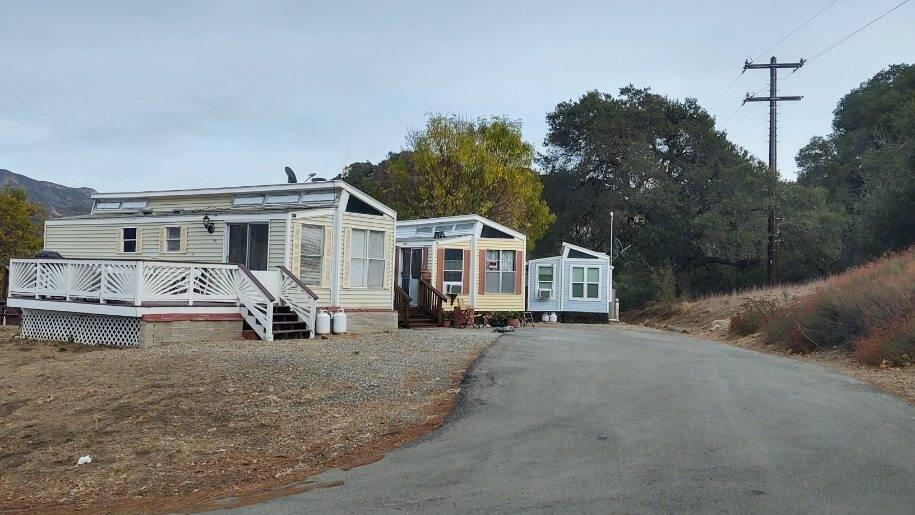 3750 Paradise Road, Unit 100 Santa Barbara, CA 93105 - Photo 9 of 14 a view of a white house with a big yard and large trees