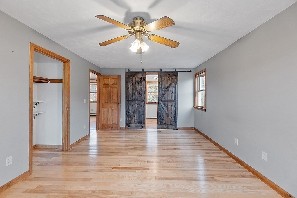 88 North End Road Townsend, MA 01469 - Photo 11 of 42 an empty room with wooden floor and windows