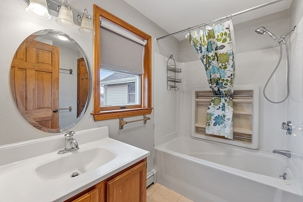 88 North End Road Townsend, MA 01469 - Photo 12 of 42 a bathroom with a sink a mirror a vanity and a bathtub