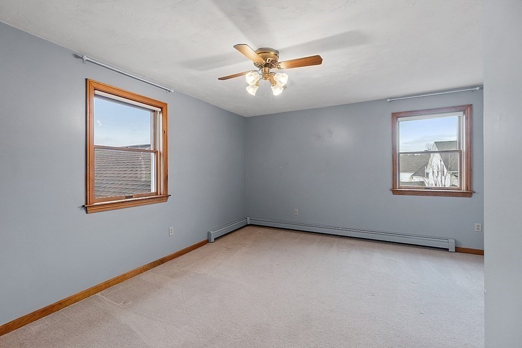 88 North End Road Townsend, MA 01469 - Photo 21 of 42 an empty room with a window and a ceiling fan