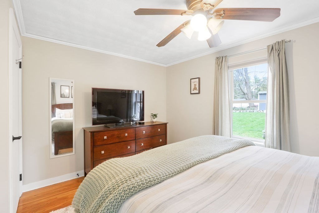 51 Forest Street Reading, MA 01867 - Photo 11 of 22 a bedroom with a bed and a flat screen tv