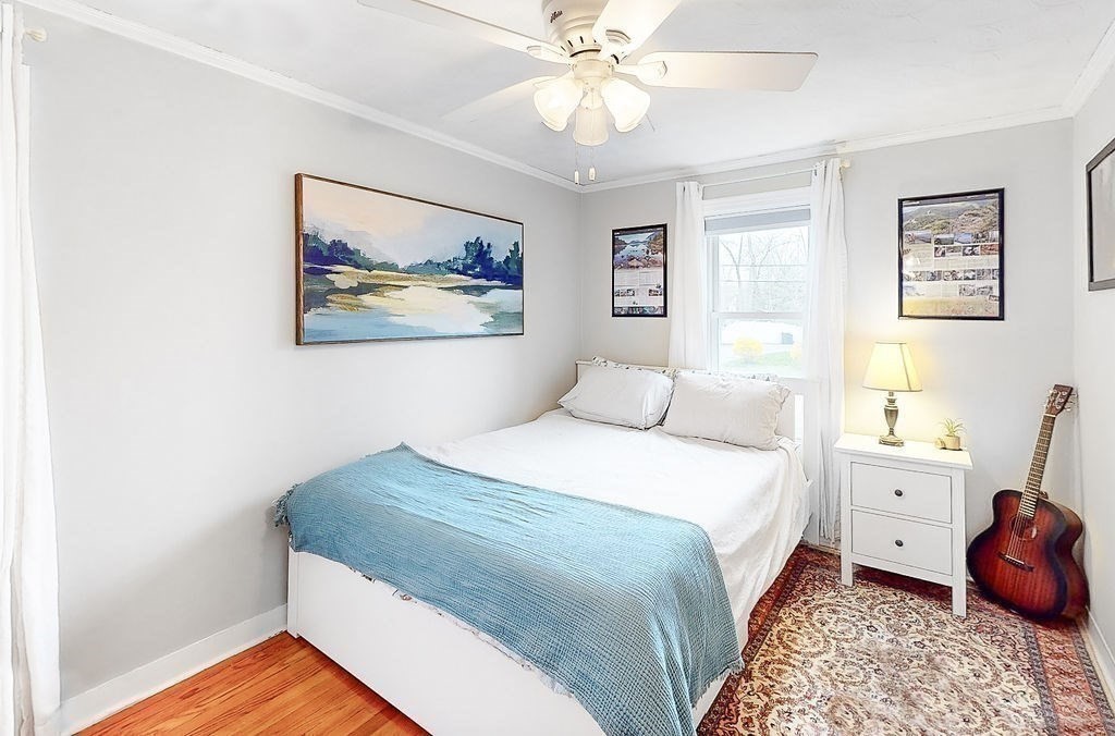 51 Forest Street Reading, MA 01867 - Photo 12 of 22 a bedroom with a bed and a chandelier