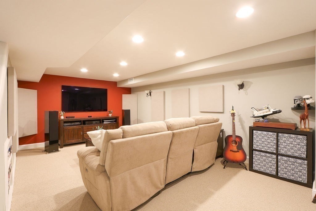 51 Forest Street Reading, MA 01867 - Photo 14 of 22 a living room with furniture and a flat screen tv
