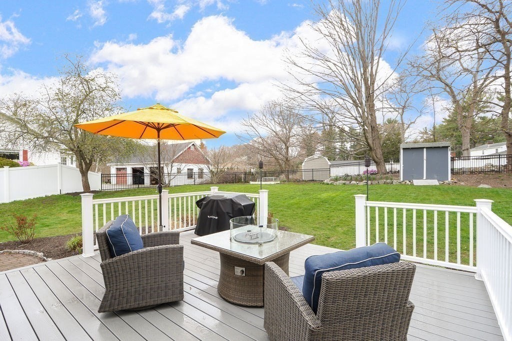 51 Forest Street Reading, MA 01867 - Photo 19 of 22 a view of a deck with couches under an umbrella