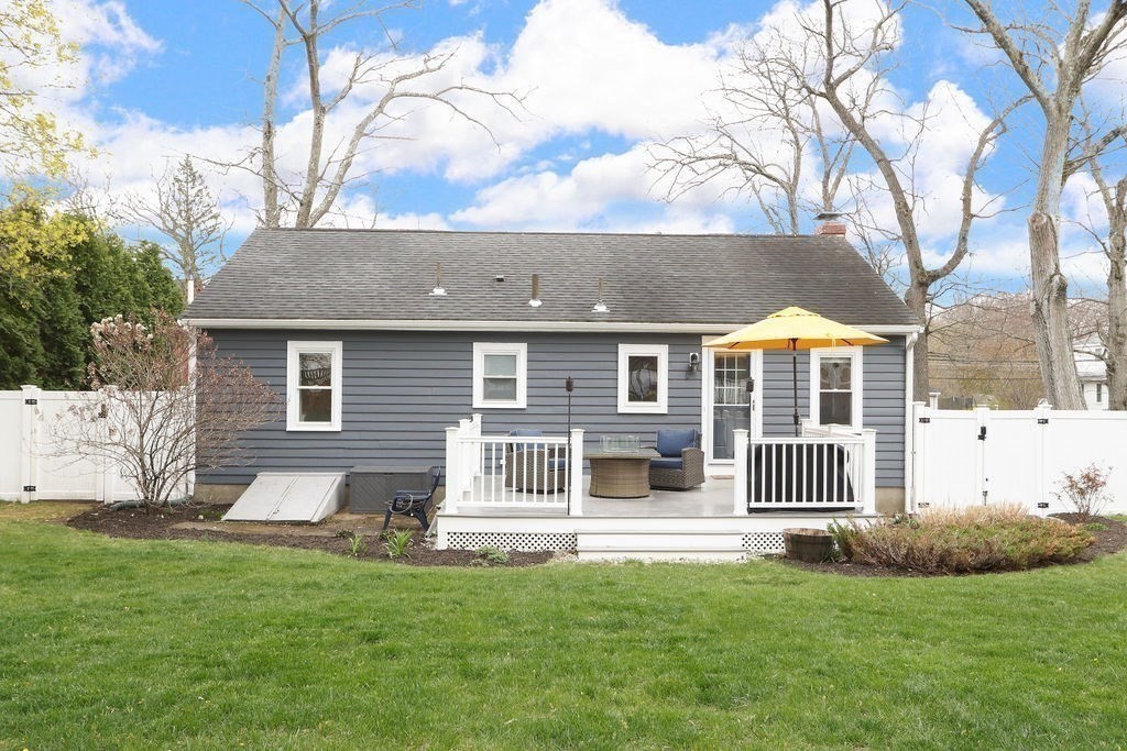 51 Forest Street Reading, MA 01867 - Photo 20 of 22 a front view of a house with a yard