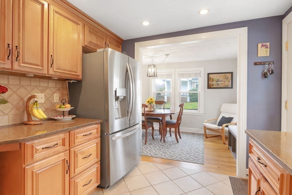 51 Forest Street Reading, MA 01867 - Photo 5 of 22 a kitchen with stainless steel appliances granite countertop a refrigerator and a stove top oven
