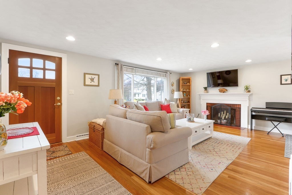 51 Forest Street Reading, MA 01867 - Photo 7 of 22 a living room with furniture a flat screen tv and a fireplace