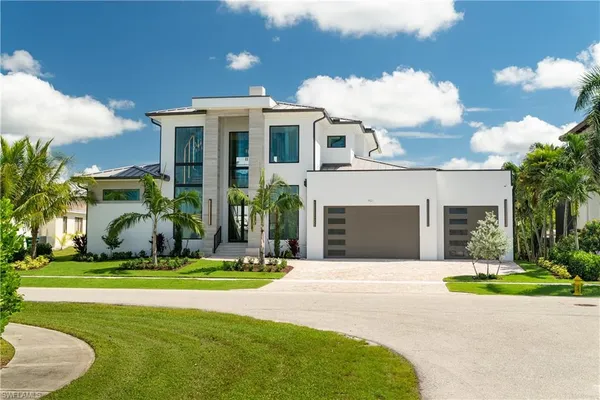 a front view of a house with a yard and garage