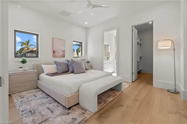 a spacious bedroom with a bed and a chandelier
