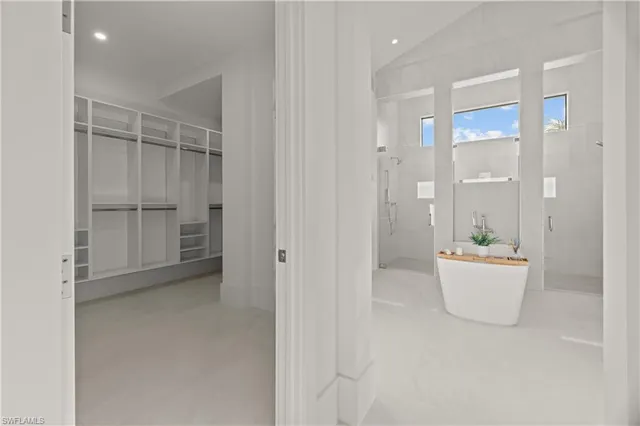 a view of an empty room and a kitchen