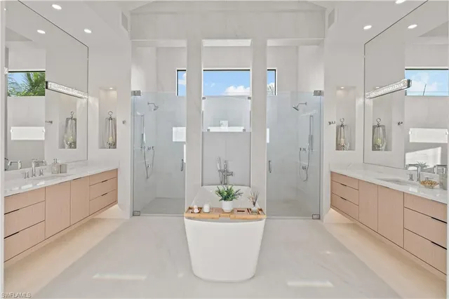 a bathroom with a granite countertop tub sink shower and mirror