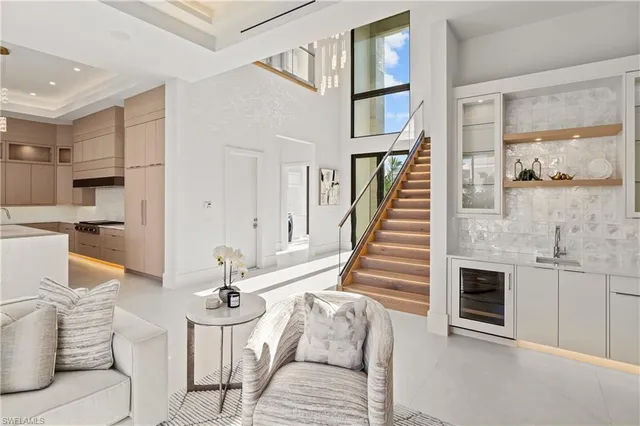 a living room with furniture a fireplace and kitchen view