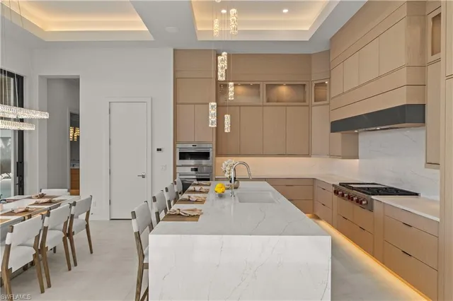 a kitchen with granite countertop a sink stove and cabinets