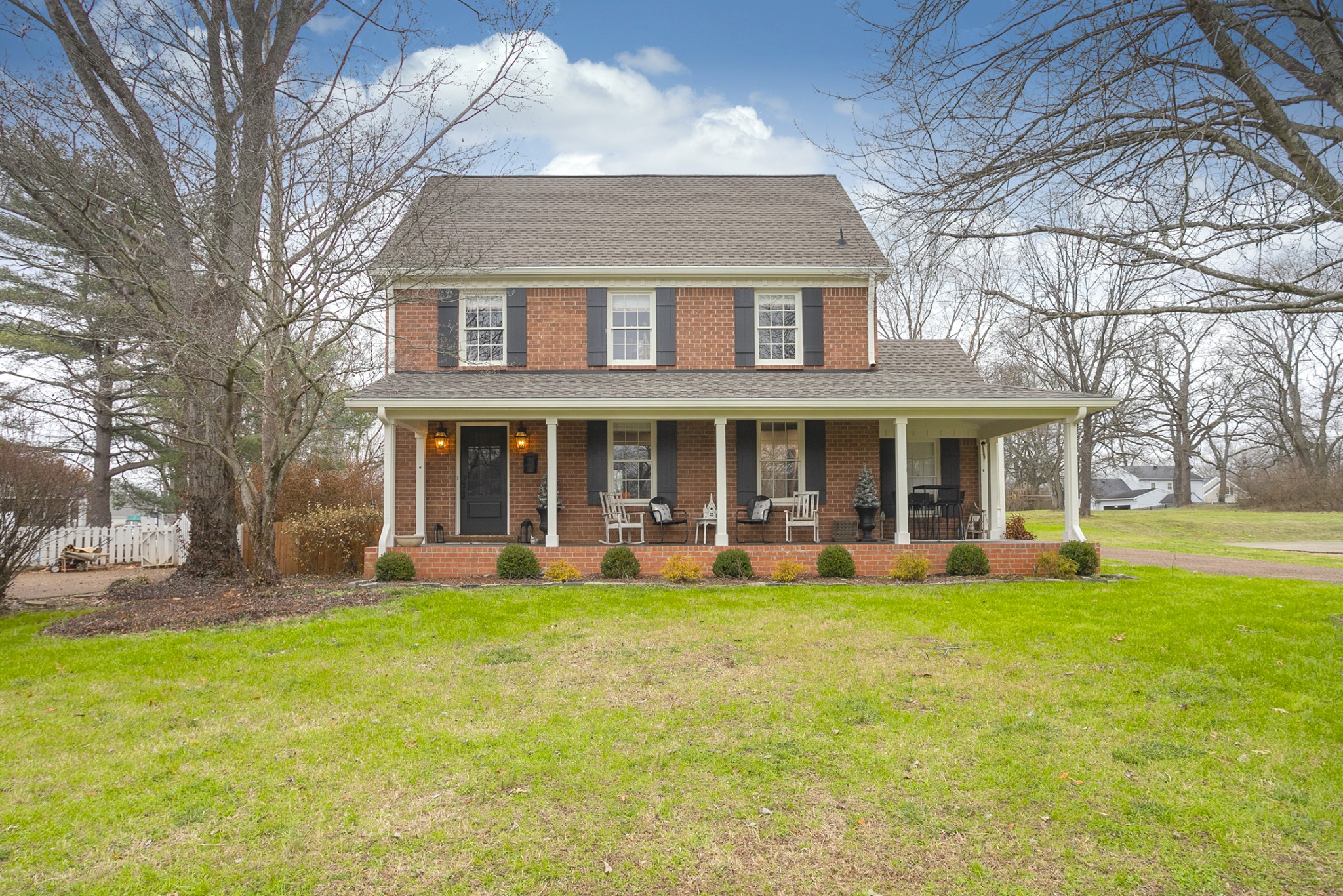 511 Arbor Drive Franklin, TN 37069 - Photo 1 of 24 a view of a white house with a large windows and a big yard with plants and large trees