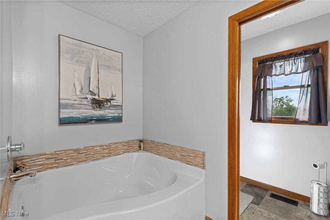 40885 Mt Hope Road Flushing, OH 43977 - Photo 19 of 50 Full bath with a bath and a textured ceiling