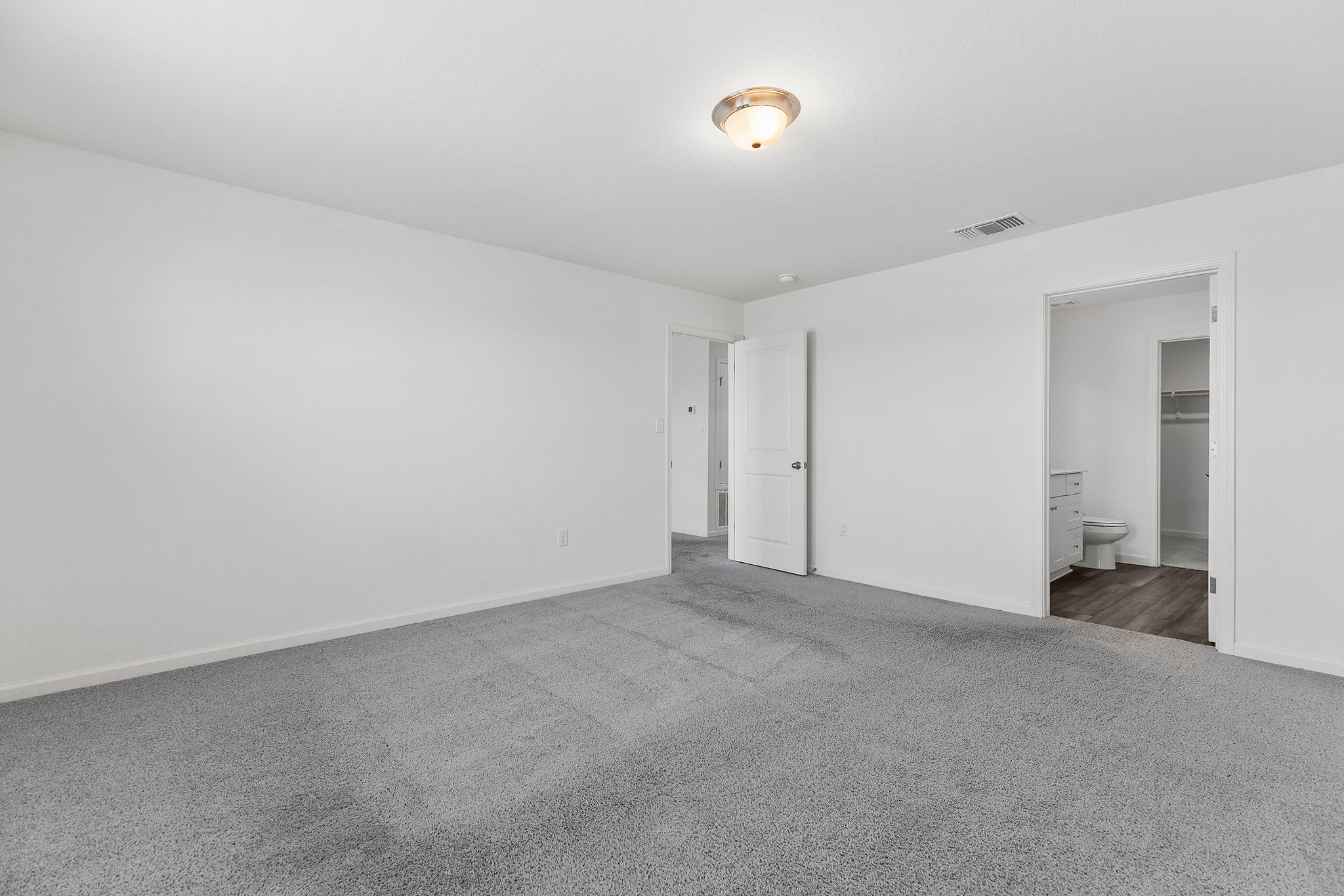 409 Line Of Fire Way Jarrell, TX 76537 - Photo 19 of 30 Spacious room featuring light gray carpeting, white walls, semi-flush mount ceiling light, baseboard trim, and open wall space for flexible furniture placement.
