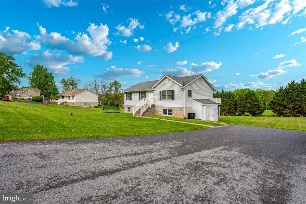 a view of a house with a yard and garage