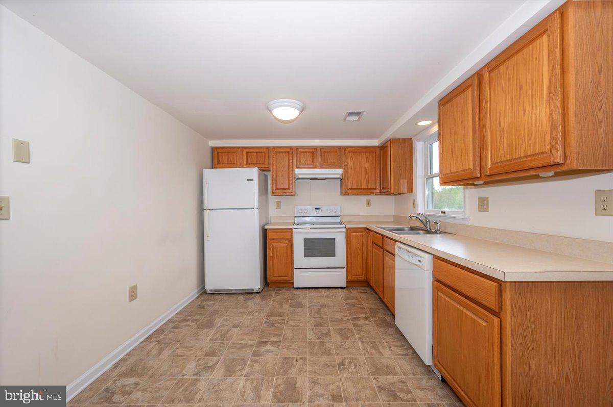 2723 Old Washington Road, Unit B Westminster, MD 21157 - Photo 13 of 37 a large kitchen with stainless steel appliances granite countertop a stove a sink and a refrigerator