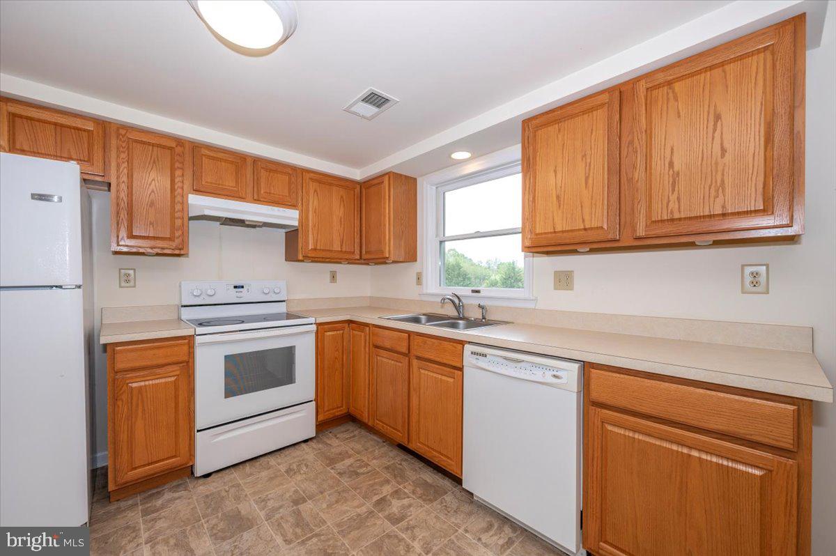 2723 Old Washington Road, Unit B Westminster, MD 21157 - Photo 15 of 37 a kitchen with stainless steel appliances granite countertop a stove a sink dishwasher and a refrigerator