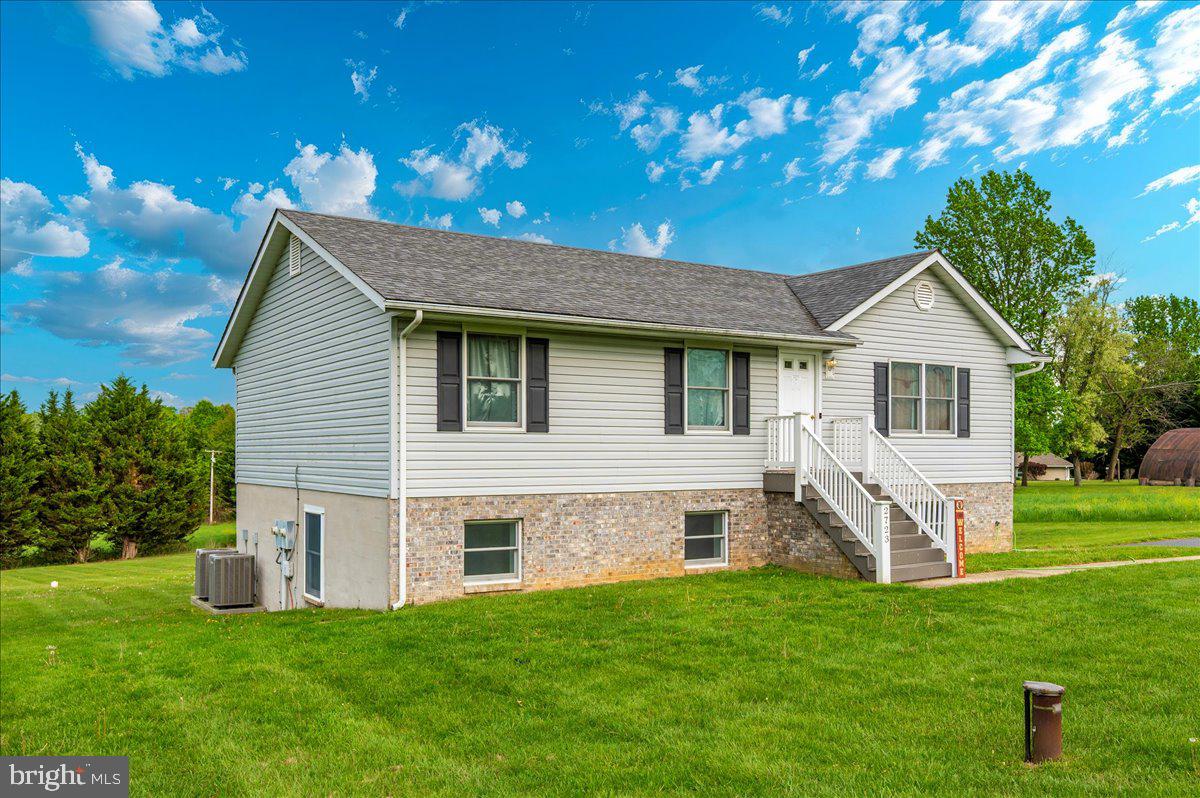 2723 Old Washington Road, Unit B Westminster, MD 21157 - Photo 34 of 37 a front view of a house with a garden and yard