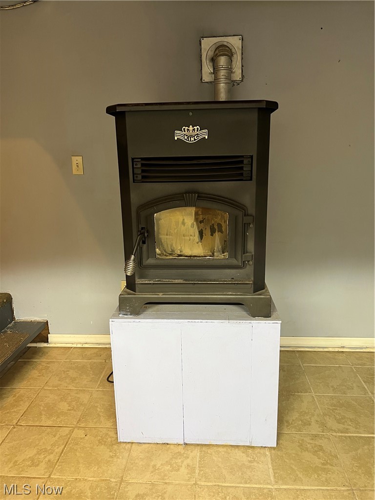 6950 Walker Road Walker, WV 26180 - Photo 18 of 22 Details featuring a pellet stove and light tile floors