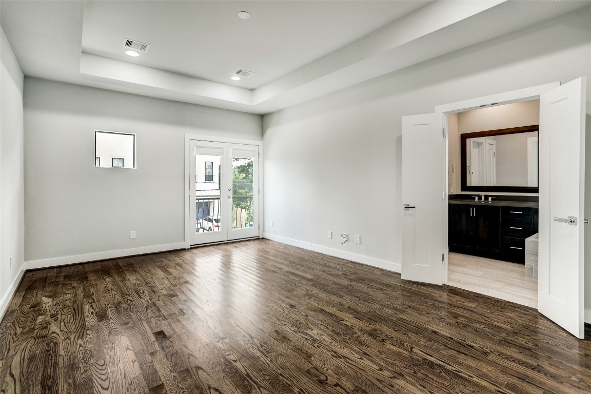 1309 Laird Street, Unit A Houston, TX 77008 - Photo 12 of 22 a view of an empty room with window and wooden floor